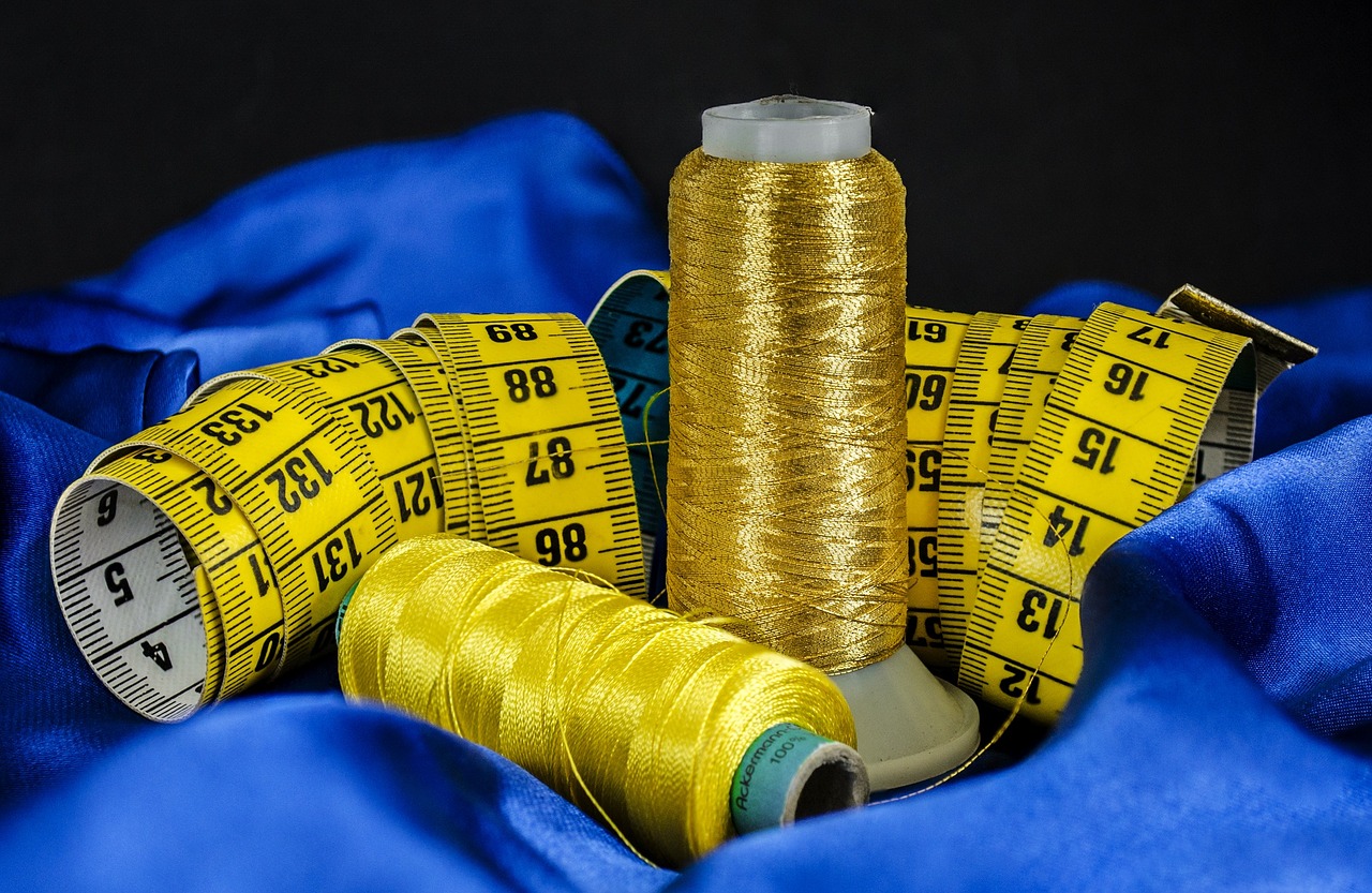A Tailor's Tools Thread, Measuring Tape, Blue Cloth